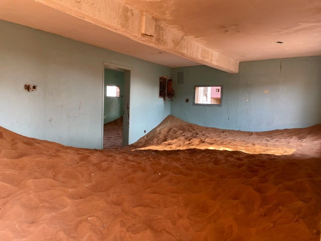 Al Madam house in desert buried by sand