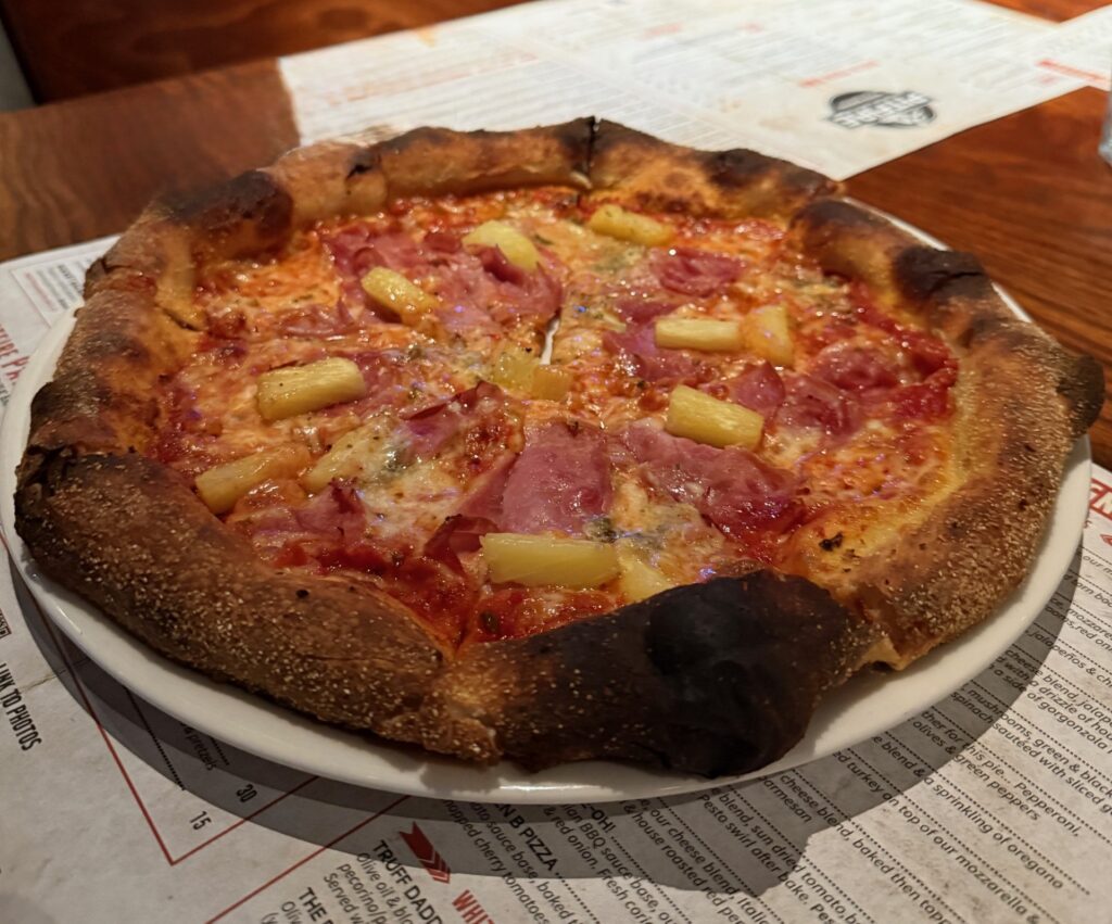 10-inch Hawaiian pizza topped with turkey ham and pineapple on a golden crust, served fresh at Pitfire Pizza Dubai Hills.