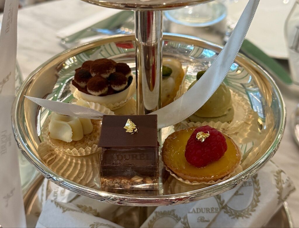 Assorted French petit fours served on a tower at Ladurée Dubai Hills Mall Royal Afternoon Tea.