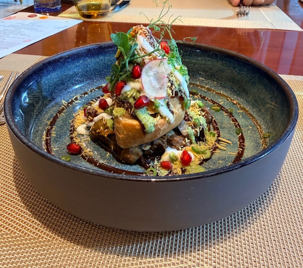 Samosa chaat at Punjab Grill Dubai with crispy samosa, chutneys and yoghurt topping