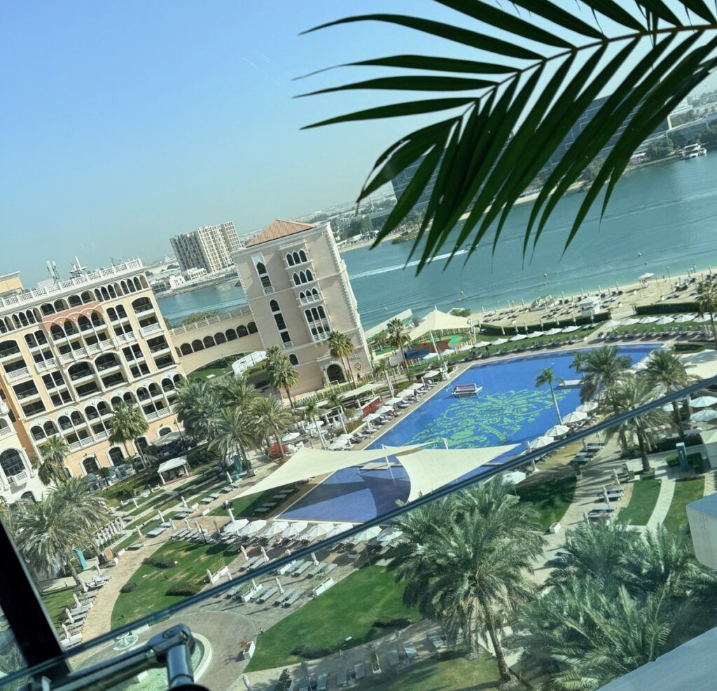 The pool area at Ritz Carlton Abu Dhabi Grand Canal with sunbeds