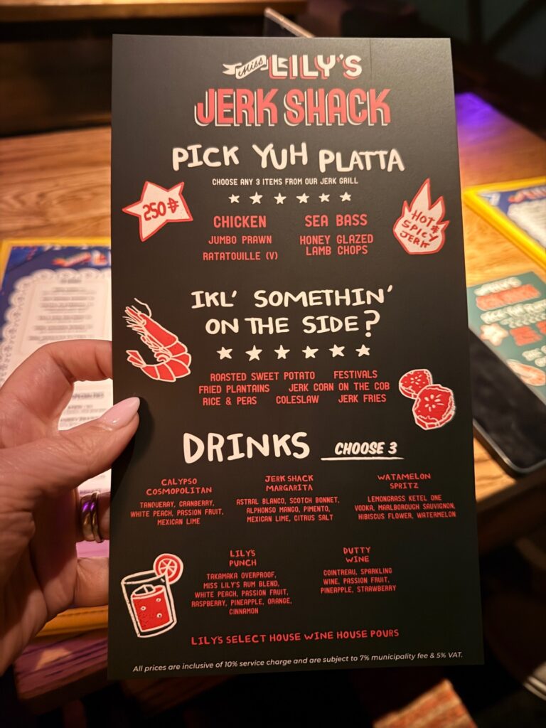 Jerk ‘n Lime AED 250 package menu at Miss Lily’s Caribbean restaurant in Dubai, showing unlimited jerk platter, sides, and drinks.