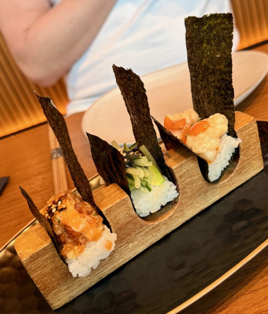 Chef’s temaki selection at Reif Japanese Kushiyaki in Dubai with avocado cucumber, spicy salmon, and crispy ebi hand rolls.